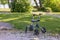 Close-up view of rolling walker left outside on green nature landscape background.