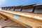 Close-up view of roof detail with wooden rafters and roof tiles. New house under construction.