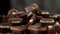 Close up view on rotating pieces of chocolate on the table with black and white background. A lot of different chunks of