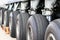 Close up view of a row of tires on the main landing gear of a large transport plane