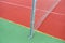 Close up view of a rubber broken tennis net. Untidy land