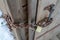 Close up view of rusty iron metal chain with gold plated combination padlock