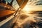 Close-up view of a sailing boat at sunset driving in blue sea.