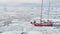 Close-up view. Sailing Yacht Sail in Antarctic melting ice. Dangerous Frozen Ocean