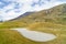 Close up view of sand trap and fairway of a golf course under cloudy blue sky