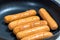 Close Up view of sausages fried in a pan, Sensitive Focus,