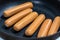 Close Up view of sausages fried in a pan, Sensitive Focus,