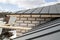 close up view of scaffolding and house under construction with grey folding roof on waterproofing layer