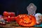 Close up view of scary orange pumkin on a wooden table for halloween celebration