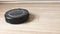 Close-up view on a self-moving robotic vacuum on the floor.