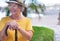 Close-up view of senior attractive woman suffering from back pain sitting outdoors with hands resting on the cane