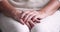 Close up view of senior woman folded wrinkled hands