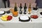 Close up view of served table with white cloth. Colorful fruits and vegetables, salads and snacks.