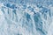 Close up view of shining white blue huge glacier freeze ice in sunny day at Perito Moreno glacier in Los Glaciares National Park,