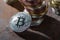 close up view of silver bitcoin leaning on stack of