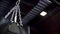 Close-up view of silver chain and swaying black punching bag, action, sport concept. Swinging chain with hanging boxing
