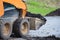 Close up view of a skid steer loader transports soil