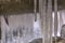 Close up view of smooth and shiny icicles under a bridge in winter