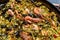 Close up view of a Spanish seafood paella: mussels, king prawns, langoustine, haddock.