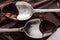 Close up view of spoons covered of chocolate on melted chocolate background.