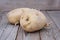 Close up view of sprouted potato on wooden background