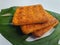 Close up view of a stack of crackers biscuit on an ornamental green monstera leaf.