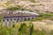 A close up view of a steam train being pushed up the gradiant of the viaduct at Glenfinnan, Scotland