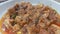 A close up view of stewed chicken meat cubes with spices on it