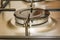 Close-up view of a stove burner in a metal kitchen