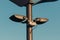 close up view of street lights on pole with blue sky