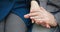 Close-up view of strong elderly male hands with clock embracing the squeezing and ironing female hands. Loving senior