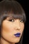 Close-up view of stylish Asian woman wearing blue lipstick