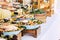 Close up of view of table full of food with someone taking pasta of the table to celebrate - caucasian woman