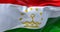 Close-up view of the Tajikistan national flag waving in the wind