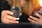 Close-up view, Take away paper coffee black cup in woman hand.