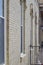 Close up view of tall narrow arched windows on a beige brick wall texture background