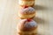 Close up view of tasty Jelly Doughnuts with jam on wood background. Hanukkah celebration concept.