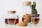 close-up view of tea in glasses, tasty cookies, teapot and cactus in pot on grey