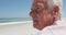 Close up view of thoughtful senior caucasian man sitting on the beach