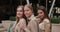 Close up view of three attractive girls looking to camera and smiling. Portrait of stylish female friends with shopping