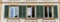 Close up view of three windows with wooden window shutters in green