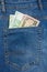 Close Up View to 100 euro and 50 dollar Banknotes Sticking Out From a Blue Jeans Pocket