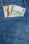 Close Up View to Euro, Koruna, Forint Banknotes Sticking Out From a Blue Jeans Pocket