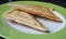 A close up view of a toasted sandwich on a plate.