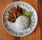 Close-up view, top view of Thai food, stir-fried with curry paste, chicken and rice in a dish with delicious vegetables