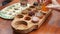 Close-up view of tourists hands and tray with various coffee and tea drinks at kopi luwak farm during the degustation