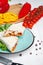 Close up view on traditional Arab shawarma, shaurma or kebab on blue plate stands on white background. Freh doner with ingridients