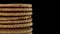 Close up view on traditional Dutch and Holland stroopwafels rotate or spin on a black mirror on a black background
