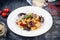 Close up view on traditional italian pasta with seafood served on dark background. Flat lay italian cuisine with copy space for