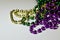 Close up view of traditional Mardi Gras beads on white background